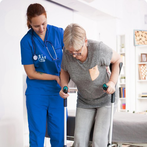 nurse helping elderly woman