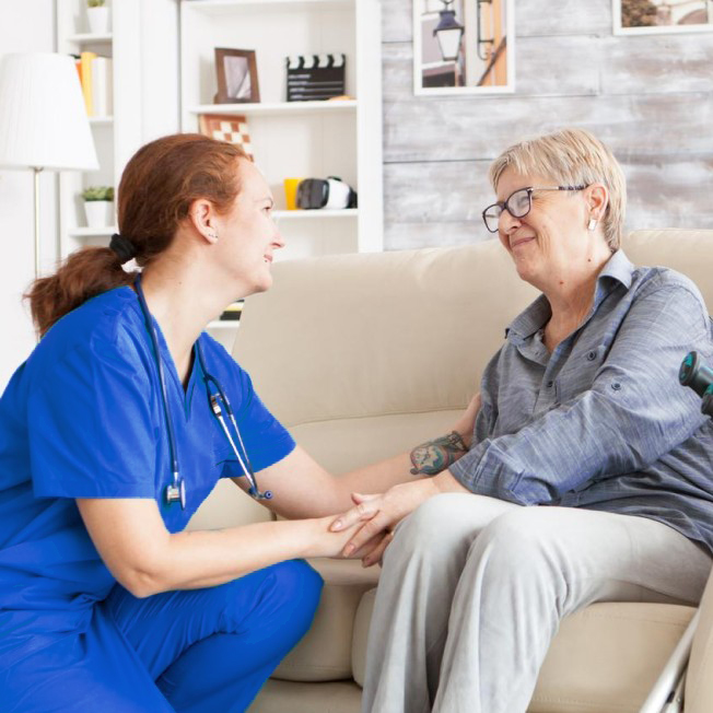 nurse helping elderly woman