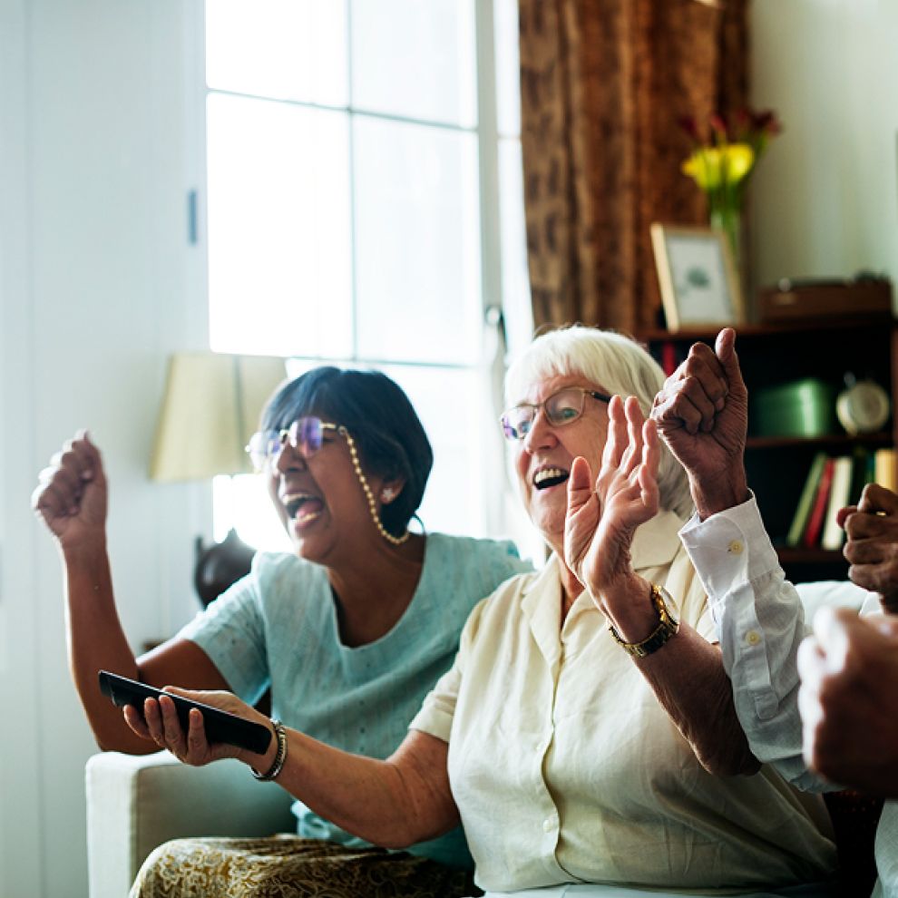 two elderly people laughing