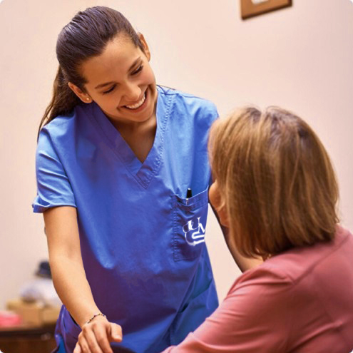 nurse helping elderly woman